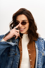Young stylish woman showcases trendy outfit in a modern studio setting