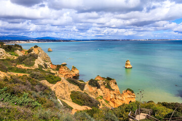Ponta da Piedade - famous rock formations with caves and grottoes on the ocean shore in Lagos,...