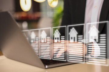 Real estate agent using laptop at table, closeup. Database on virtual screen