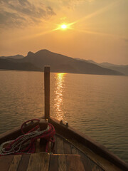 Sunset View from Wooden Boat on Serene Lake