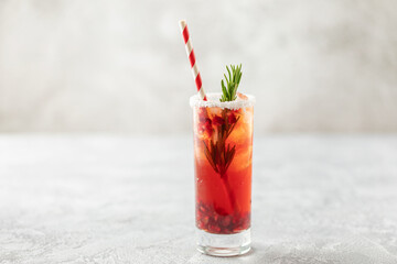 Festive alcoholic cocktail with  pomegranate and vodka in highball on the table