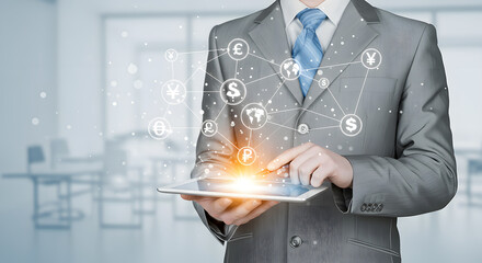 Businessman using a tablet depicting global finance and digital currency transactions across networks.