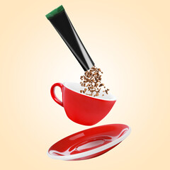 Instant coffee falling from sachet into cup against beige background