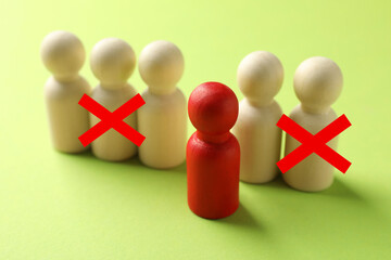 Dismissal. Two human figures with red crosses among others on light green background. Red figure - boss or HR manager