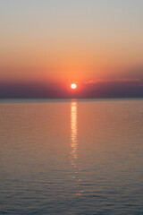 Stunning sunset over calm water creates a serene atmosphere in the evening sky
