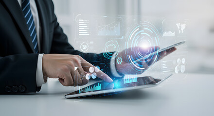 Businessman analyzing data and technology using tablet computer with futuristic user interface