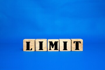 LIMIT word on cube wood. light blue background. cube wood concept.