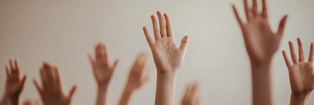 Young students raising hands enthusiastically, engaging with teacher's question during classroom learning session, displaying curiosity and academic involvement