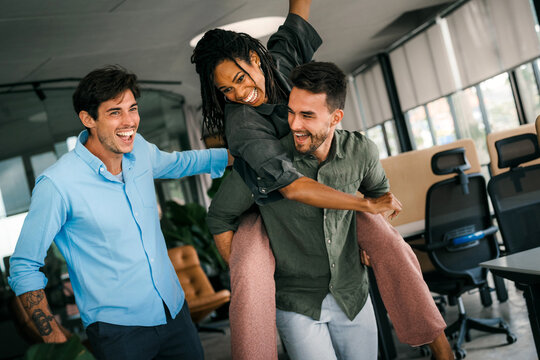 Happy diverse multiethnic colleagues having fun together, enjoying the celebration success in office