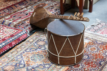 Traditional Drum and String Instrument on Ornate Patterned Rugs