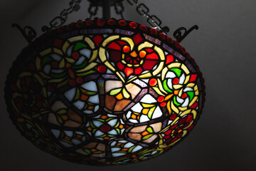 Stained Glass Decorative Lamp with Floral Patterns Against a Dark Background