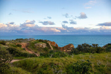 Ponta da Piedade - famous rock formations with caves and grottoes on the ocean shore in sunset time...