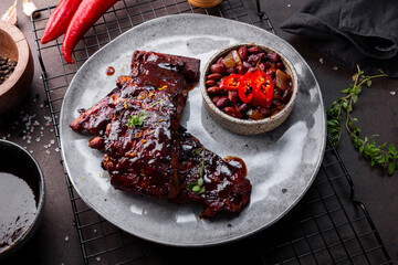 Roasted Pork Ribs in BBQ Sauce with Red Beans in the plate