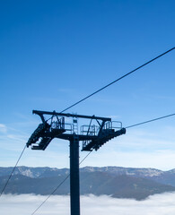 A ski lift is suspended high above a mountain range