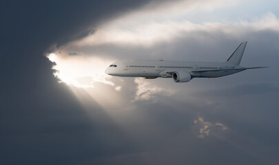 White passenger airplane flying in the sky amazing clouds in the background - Travel by air transport