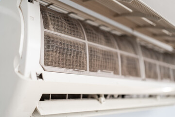 Dirty in dust and mold air conditioner filter close-up. Home air conditioner maintenance