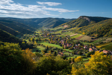 Fototapeta premium Vibrant Autumn Landscape Overlooking Rolling Hills and Valleys Under a Clear Blue Sky