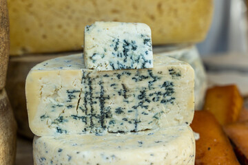Blue cheese wedges showing mold growing on cheese wheels