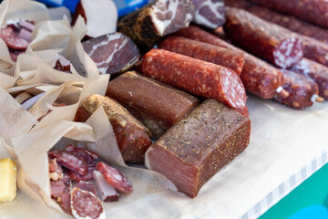Variety of smoked and cured meat products displayed on table