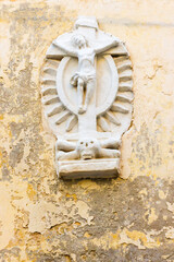 Wall Mounted Religious Sculpture Depicting Crucifixion Scene in Weathered Stone