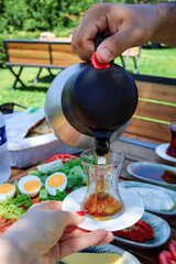 Pouring Turkish Tea at Breakfast