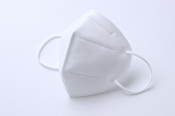 Close-up of a white protective face mask with elastic ear loops and minimalist design for health safety and personal protection