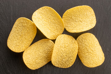 Crispy potato chips, top view, macro.