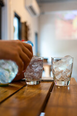 Air conditioning technician repairs AC unit indoors. Male worker in red uniform fixes air conditioner. Maintenance service. Repairman installs portable cooling system, cleans filter. Pro worker at