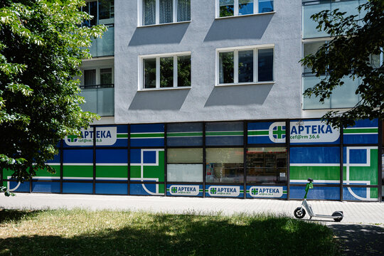 Modern pharmacy Cef@Rm 36,6 storefront with scooter outside in Warsaw, Poland on a sunny day