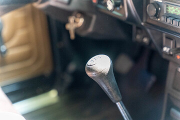 Gear stick showing four speed plus reverse in vintage car interior