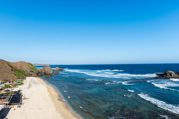 Lombok, Indonesia, Beach ocean sunset drone aerial view landscape at Seger beach area. Lombok is an island in West Nusa Tenggara province, Indonesia.