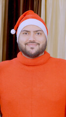 Vertical Photo of Indian Man Waving Hello with Christmas Tree in background