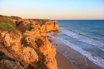 Ponta da Piedade - famous rock formations with caves and grottoes on the ocean shore in sunset time...