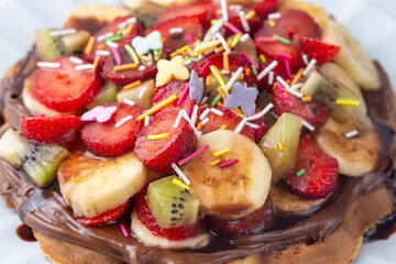 Fruit waffles, chocolate bananas, strawberries, chocolate fries, handmade Turkish waffles and pistachios