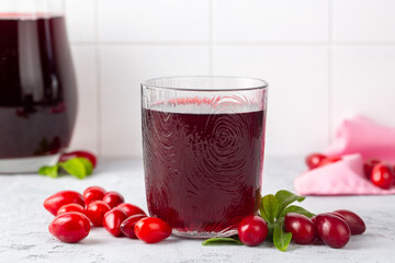 Glass of healthy dogwood berry drink on light background. Turkish name; Kizilcik serbeti
