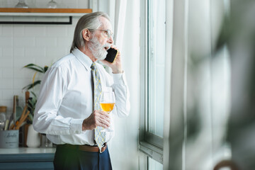 Senior businessman in formal shirt holding smartphone, appearing stressed during phone call lay off...