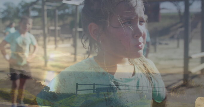 Girl catching breath in green tee at playground with metal frame bars, woodchip ground, copy space - Powered by Adobe