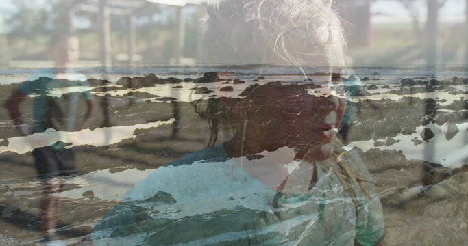 Friends climbing metal playground bars at outdoor park, with rocky tide pool patterns - Powered by Adobe
