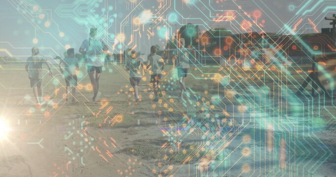Running man in sportswear leading six children on beach, lifeguard tower, digital circuit overlay - Powered by Adobe