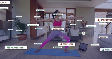 Balancing woman in pink sportswear holding yoga pose on blue mat in living room, floating labels