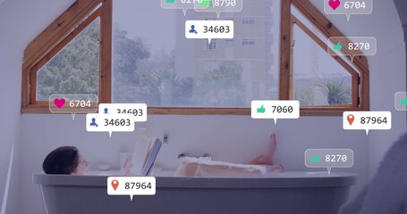 Reading woman holding book above bubble tub under skylights, with social media icons