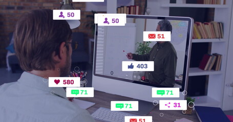 Watching man wearing glasses viewing flip chart presentation at office, with keyboard, copy space