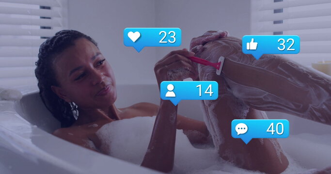Adult woman shaving leg in foam-filled tub in home bathroom with blinds, red razor, reaction icons