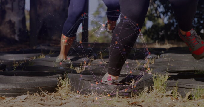 Fototapeta Stepping athletes in leggings and sneakers doing drill outdoors, with tire pattern, digital overlay