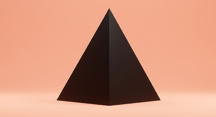 Fototapeta premium A solitary dark pyramid stands against a soft peach background in a studio setting