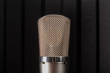 Silver studio microphone on a black background