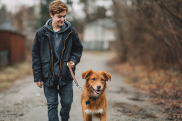 Teen walking dog adopted from shelter leash shows happy compassion