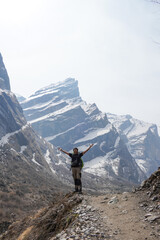 Young asian male hiker carrying mountain backpack and using trekking pole took photos after...