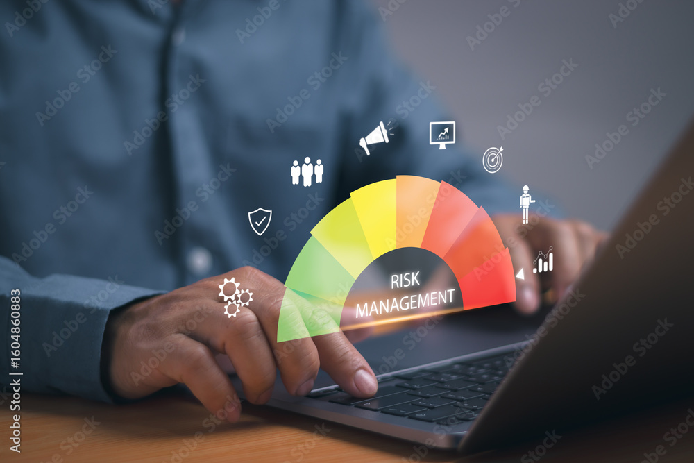 Fototapete Risk management and data analysis concept, businessman working with computer showing risk assessment of business organization performance to reduce impact of operations with virtual graphics