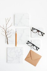 Marble Stationery Set with Glasses and Pencil on White Background